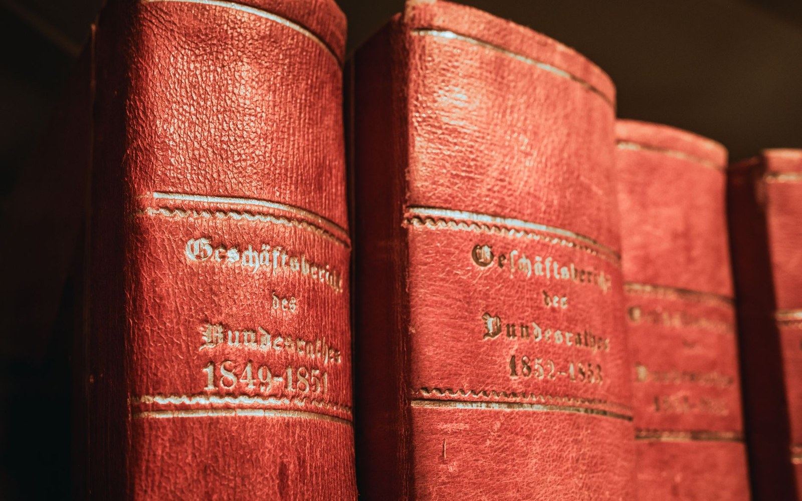 A bound volume of Punch open to a full-page political cartoon on a library table