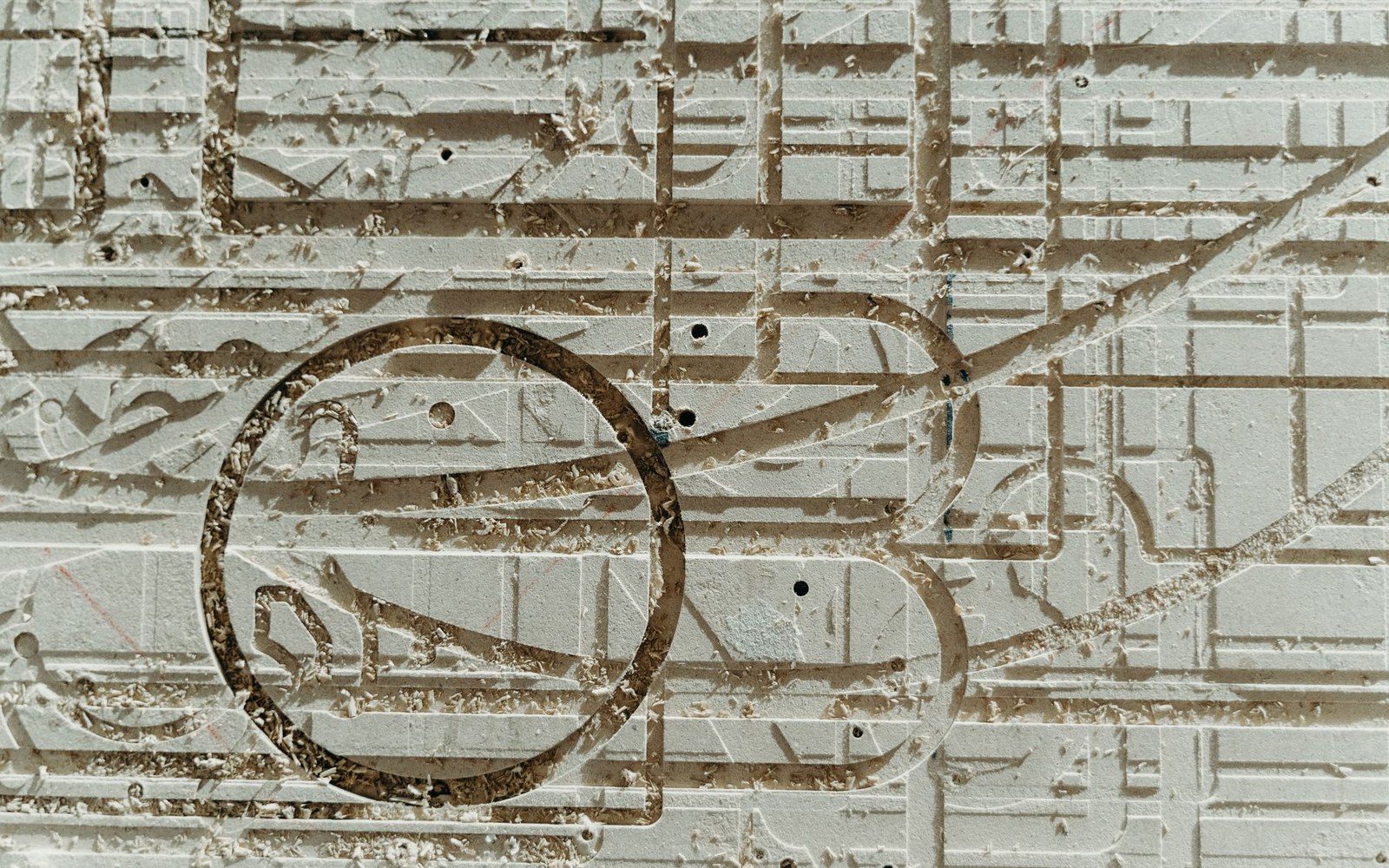 A zinc line block lying flat on a compositor's stone, close shot — surface detail of the etched image visible